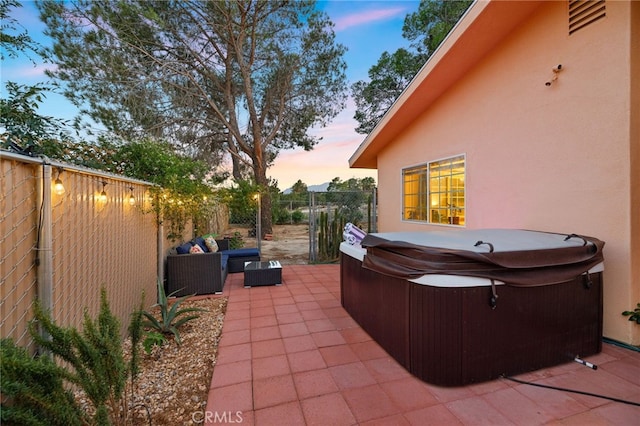 view of patio featuring a fenced backyard and a hot tub