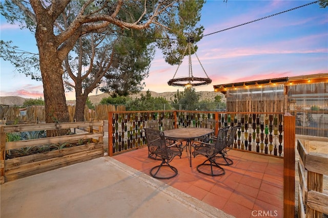 view of patio featuring fence and outdoor dining area