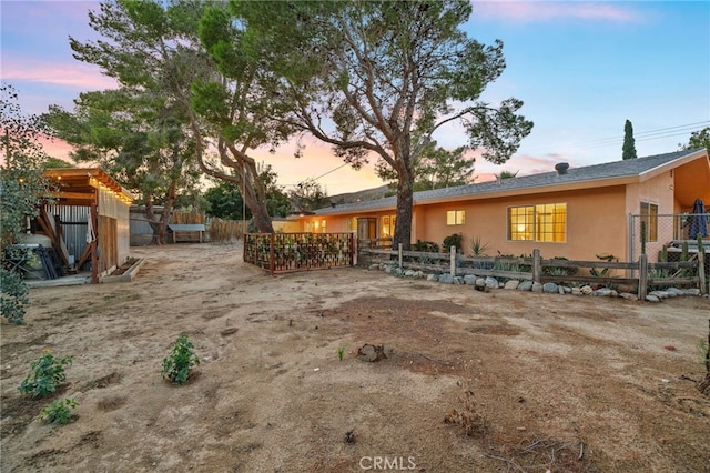exterior space with stucco siding and fence