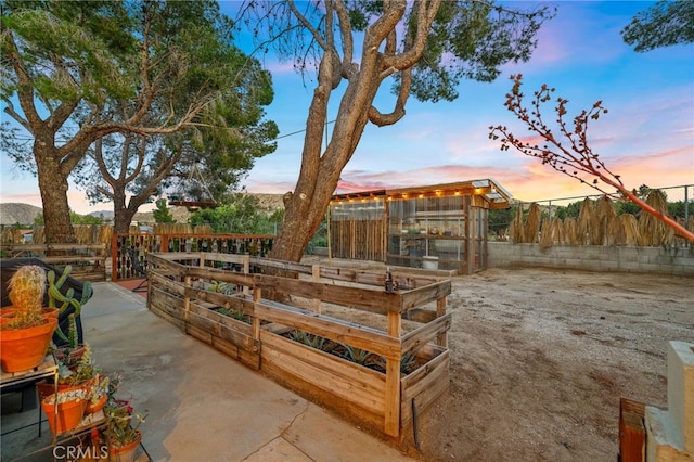 view of yard featuring an exterior structure, a fenced backyard, and an outdoor structure