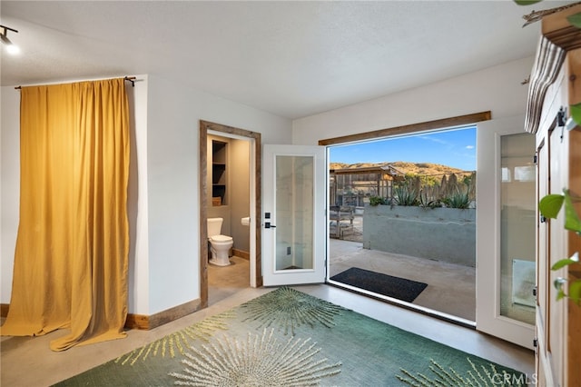 interior space featuring baseboards and concrete floors
