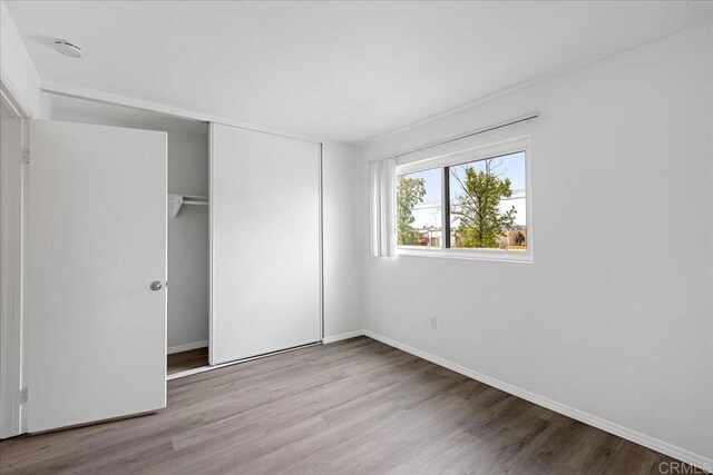 888 Cherrywood Way Unit 20, El Cajon, CA 92021 - unfurnished bedroom with a closet, baseboards, and wood finished floors