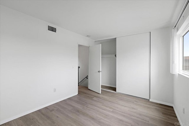 888 Cherrywood Way Unit 20, El Cajon, CA 92021 - unfurnished bedroom featuring baseboards, visible vents, a closet, and wood finished floors