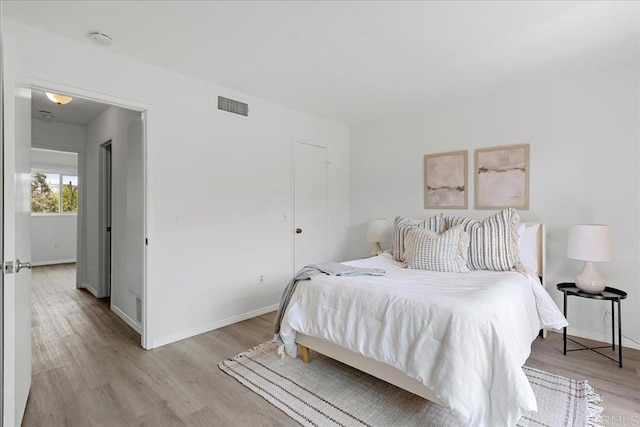 888 Cherrywood Way Unit 20, El Cajon, CA 92021 - bedroom with baseboards, visible vents, and light wood-style floors