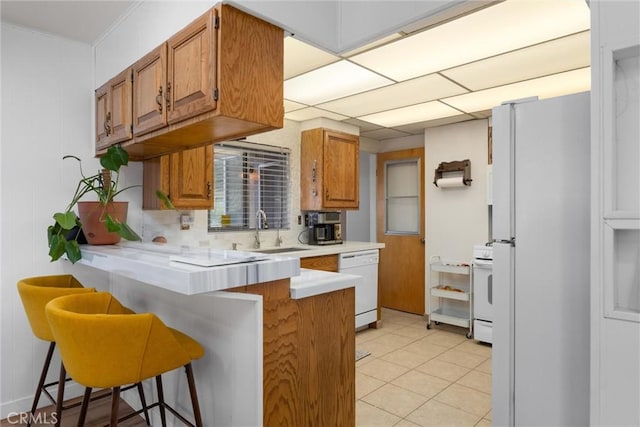 4228 Willow Trl, Frazier Park, CA 93225 - kitchen featuring brown cabinets, a sink, a peninsula, and white appliances