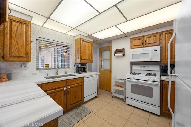 4228 Willow Trl, Frazier Park, CA 93225 - kitchen featuring light countertops, a sink, brown cabinetry, light tile patterned floors, and white appliances