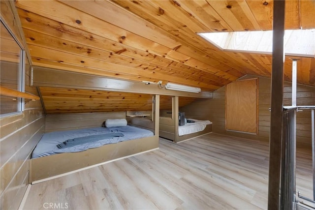 4228 Willow Trl, Frazier Park, CA 93225 - unfurnished bedroom featuring vaulted ceiling with skylight, wood finished floors, wood walls, and wooden ceiling