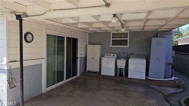 view of patio / terrace featuring separate washer and dryer and a sink