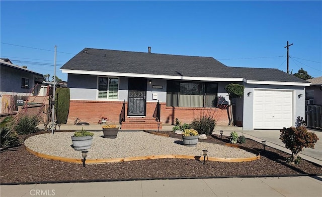 ranch-style home featuring fence, concrete driveway, stucco siding, brick siding, and a garage