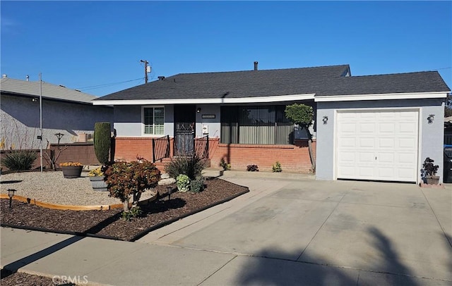 single story home with concrete driveway, brick siding, stucco siding, and a garage