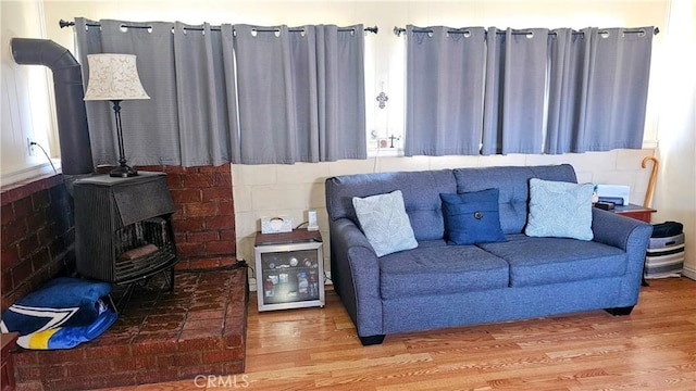 living room with wood finished floors and a wood stove