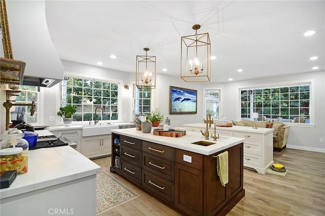 29528 Ridgeway Dr, Agoura Hills, CA 91301 - kitchen featuring a sink, a center island with sink, light countertops, extractor fan, and recessed lighting