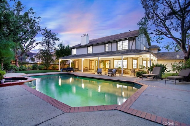 29528 Ridgeway Dr, Agoura Hills, CA 91301 - back of property featuring a patio, a chimney, a pool with connected hot tub, stucco siding, and an outdoor hangout area