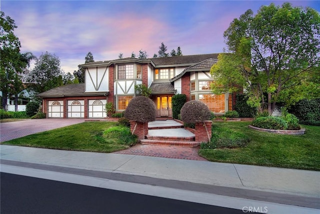 29528 Ridgeway Dr, Agoura Hills, CA 91301 - english style home with driveway, a lawn, stucco siding, and a garage