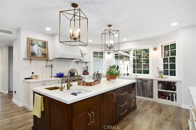 29528 Ridgeway Dr, Agoura Hills, CA 91301 - kitchen featuring stainless steel dishwasher, light countertops, wood finished floors, recessed lighting, and a sink
