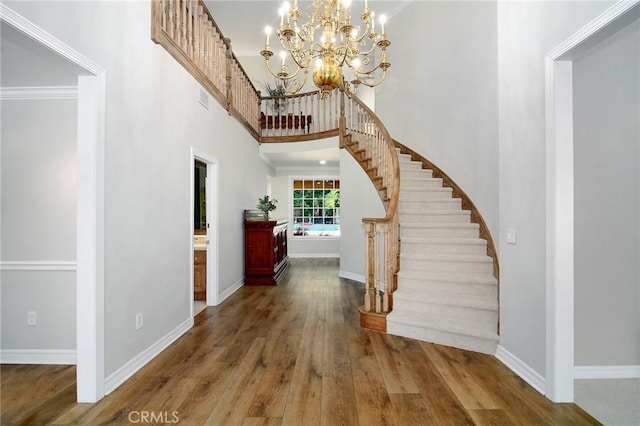 29528 Ridgeway Dr, Agoura Hills, CA 91301 - foyer with wood finished floors, stairs, a towering ceiling, baseboards, and a chandelier