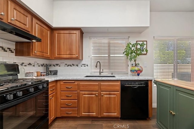 2583 W Fairview Dr, Rialto, CA 92377 - kitchen with under cabinet range hood, a sink, black appliances, and a healthy amount of sunlight
