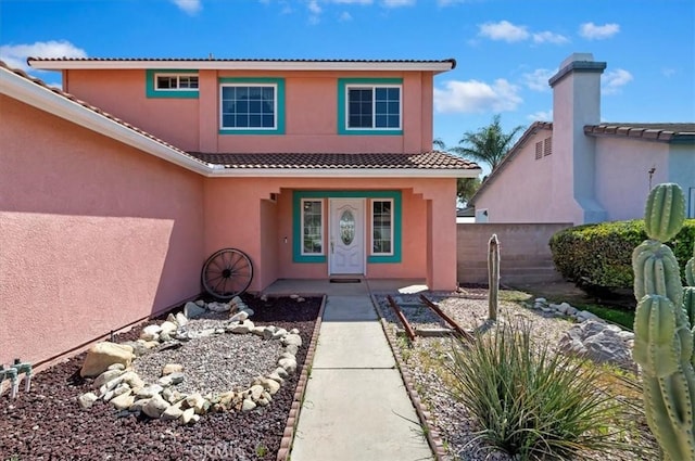 2583 W Fairview Dr, Rialto, CA 92377 - property entrance featuring a tiled roof, stucco siding, and fence