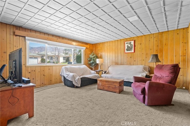 carpeted bedroom featuring wood walls