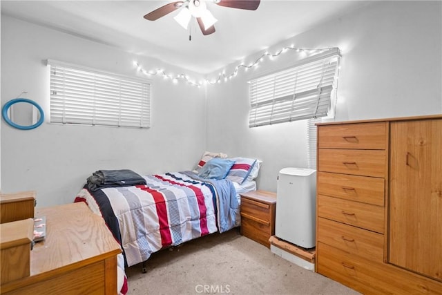 bedroom featuring light colored carpet and ceiling fan
