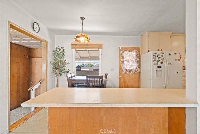 300 Palisade St, Pasadena, CA 91103 - kitchen featuring white fridge with ice dispenser, light countertops, decorative light fixtures, cream cabinets, and light tile patterned flooring