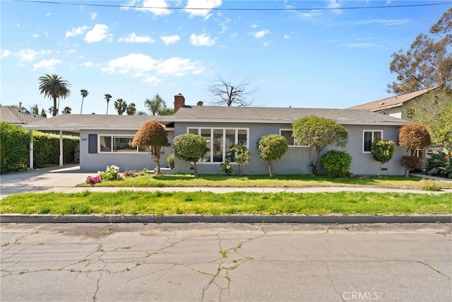 300 Palisade St, Pasadena, CA 91103 - ranch-style house with stucco siding, driveway, an attached carport, a front yard, and a chimney