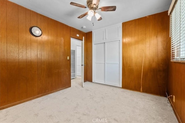 300 Palisade St, Pasadena, CA 91103 - unfurnished bedroom featuring carpet floors, wood walls, a closet, and ceiling fan