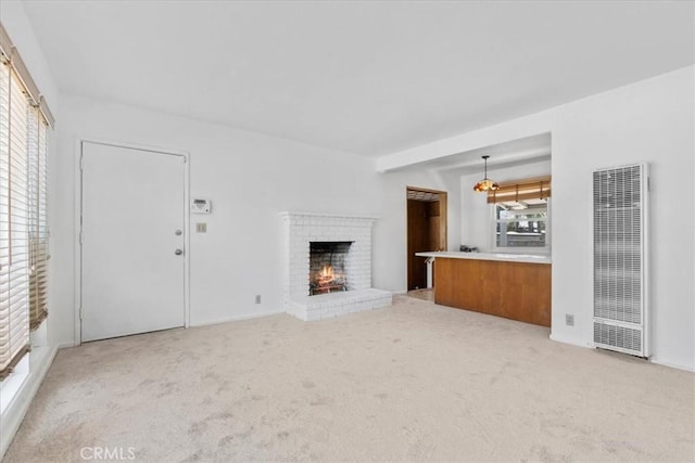300 Palisade St, Pasadena, CA 91103 - unfurnished living room with a heating unit, carpet floors, and a brick fireplace