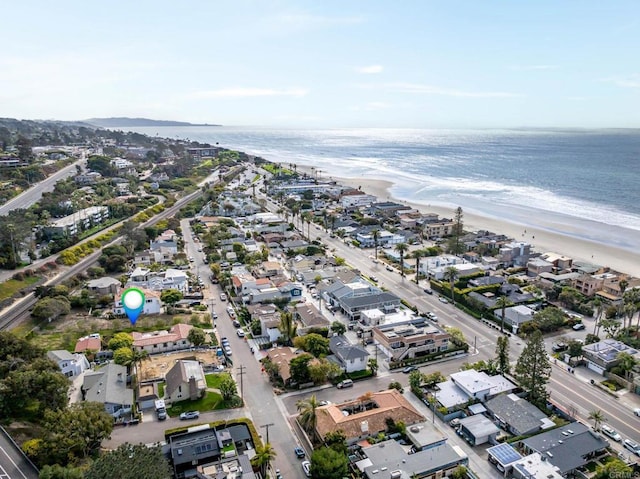 drone / aerial view with a view of the beach, a residential view, and a water view
