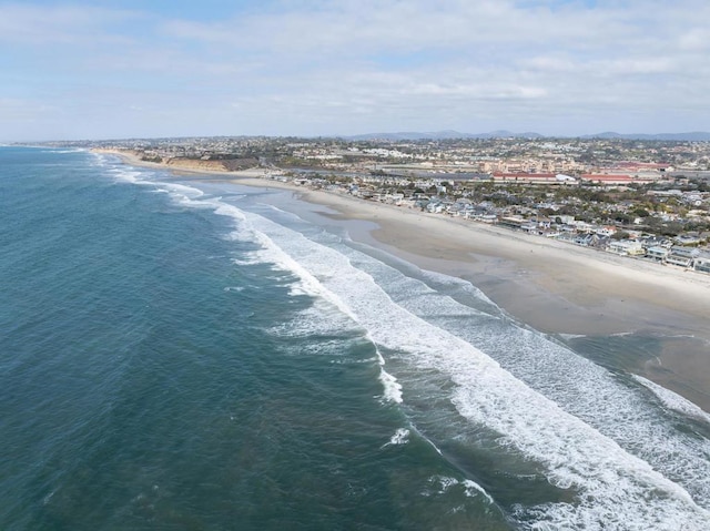 birds eye view of property featuring a view of the beach and a water view