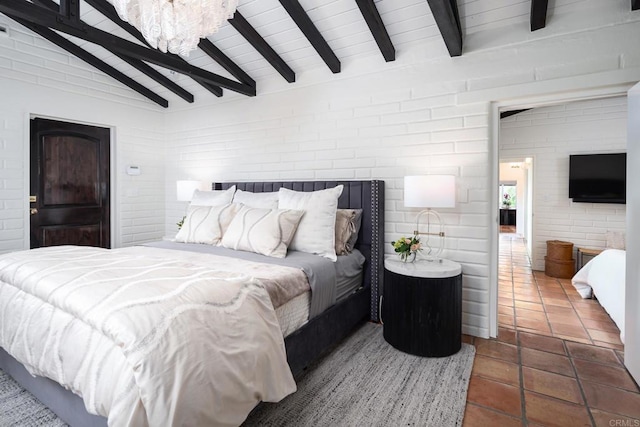 tiled bedroom featuring a chandelier and lofted ceiling with beams