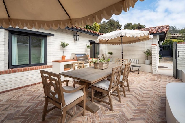 view of patio with a grill and outdoor dining space