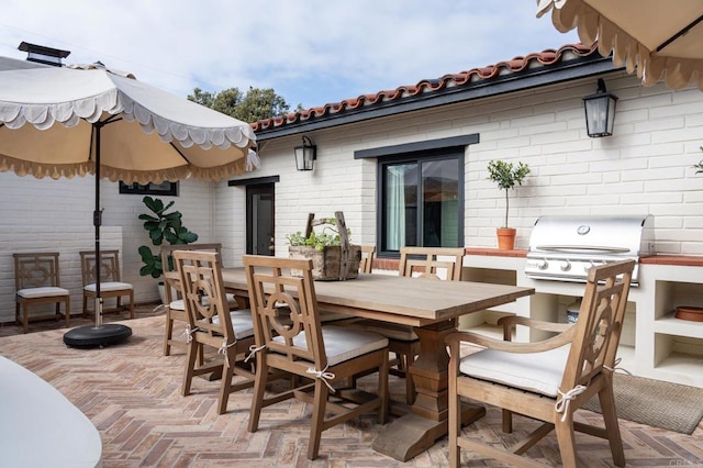view of patio / terrace with a grill and outdoor dining area