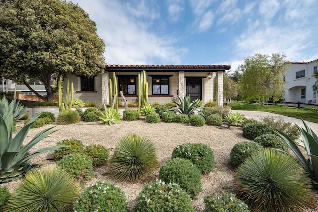 mediterranean / spanish home with a porch and a tile roof