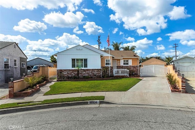 single story home with a gate, fence, a detached garage, a front yard, and brick siding