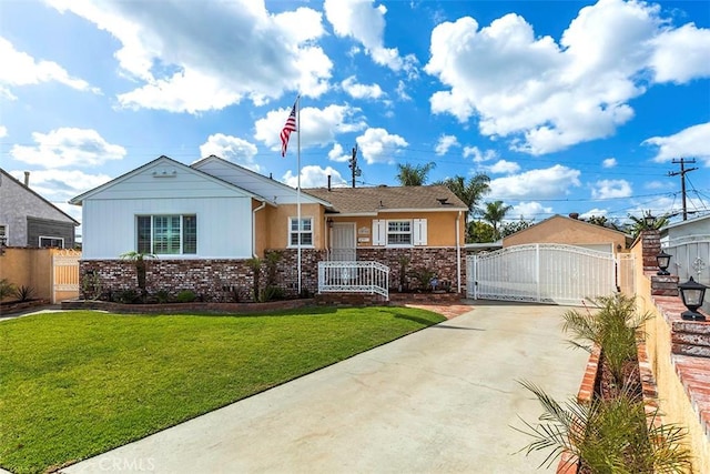 view of front of house featuring a front yard, a gate, concrete driveway, fence, and brick siding