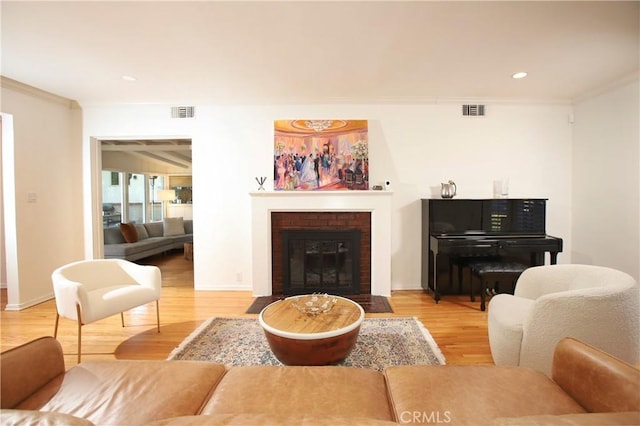 1628 Santa Rosa Ave, Glendale, CA 91208 - living area featuring light wood finished floors, visible vents, ornamental molding, and a brick fireplace