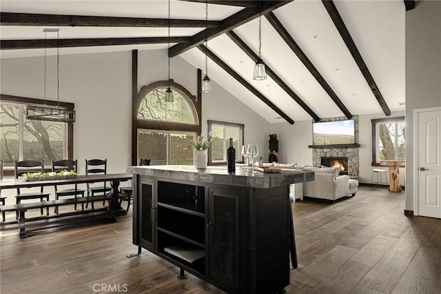 1207 Grass Valley Rd, Lake Arrowhead, CA 92352 - kitchen featuring dark cabinetry, a kitchen island with sink, open shelves, beamed ceiling, and dark wood-style flooring