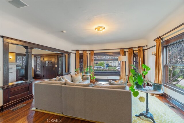 2280 W 24th St, Los Angeles, CA 90018 - living room with decorative columns, visible vents, and wood finished floors