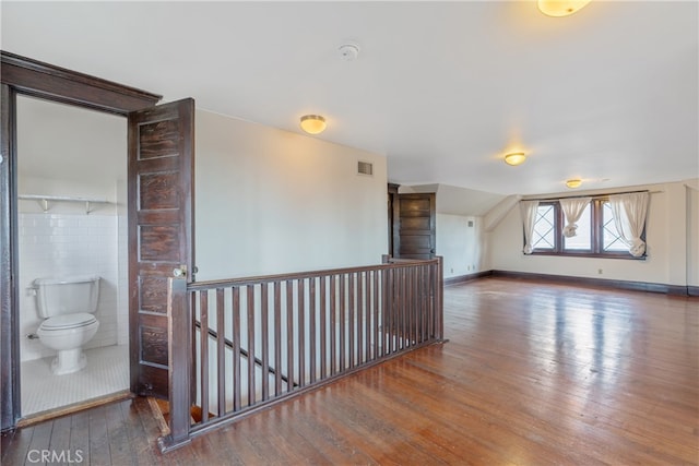 2280 W 24th St, Los Angeles, CA 90018 - additional living space with baseboards, lofted ceiling, visible vents, and wood-type flooring