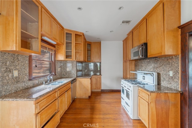 2280 W 24th St, Los Angeles, CA 90018 - kitchen featuring visible vents, a sink, stone countertops, and appliances with stainless steel finishes