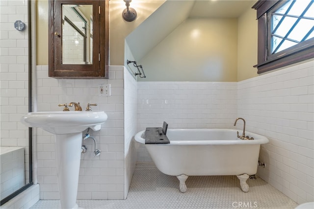 2280 W 24th St, Los Angeles, CA 90018 - bathroom with tile walls, tile patterned floors, and a soaking tub