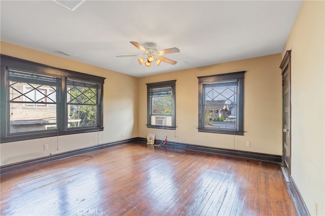 2280 W 24th St, Los Angeles, CA 90018 - unfurnished room with visible vents, baseboards, ceiling fan, hardwood / wood-style floors, and cooling unit