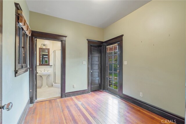 2280 W 24th St, Los Angeles, CA 90018 - unfurnished room featuring baseboards and hardwood / wood-style flooring