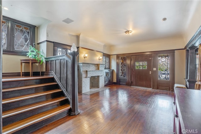 2280 W 24th St, Los Angeles, CA 90018 - foyer entrance with hardwood / wood-style flooring, stairway, a fireplace, and visible vents