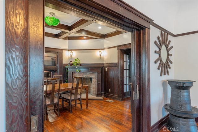 2280 W 24th St, Los Angeles, CA 90018 - dining room featuring coffered ceiling, a wainscoted wall, wood finished floors, a brick fireplace, and beamed ceiling