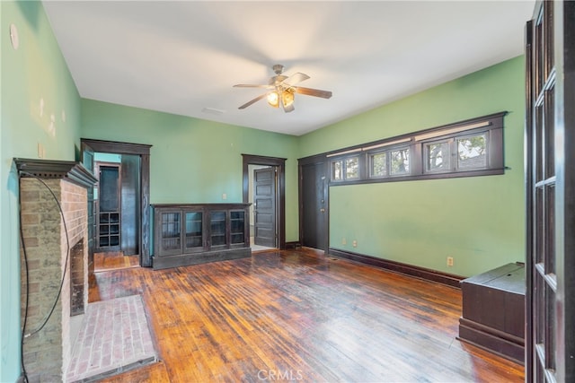 2280 W 24th St, Los Angeles, CA 90018 - unfurnished living room featuring baseboards, a fireplace, wood finished floors, and ceiling fan