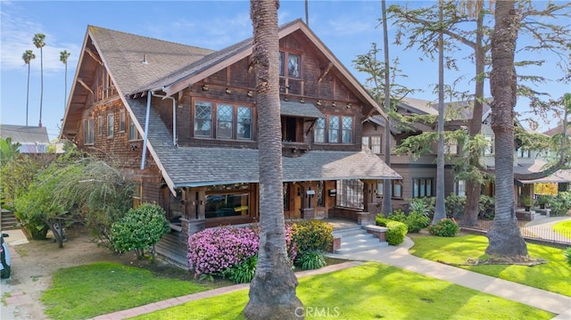 2280 W 24th St, Los Angeles, CA 90018 - view of front of property featuring a porch, roof with shingles, and a front lawn