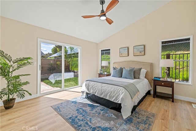 bedroom featuring vaulted ceiling, baseboards, access to outside, and light wood finished floors
