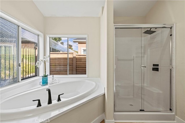 bathroom with a garden tub and a shower stall